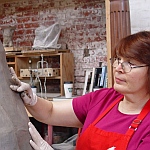 Working on the statue in clay, working on the veil of St. Aviat