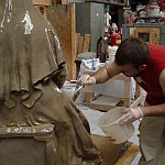 Zachary Kainz is applying the first coat of the rubber mold